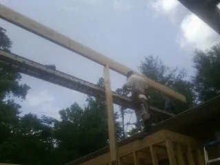 Carpenter setting a ridge beam over a new addition frame — Ice Dam Removal by Roofing Brothers in Woodcliff Lake